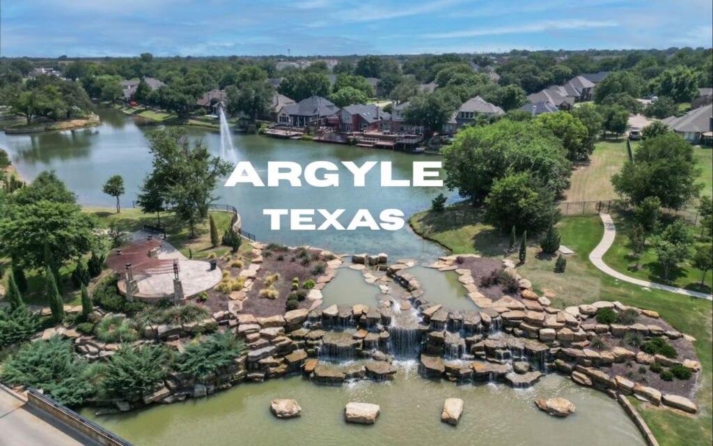 an aerial view of a lake with a small man made waterfalls