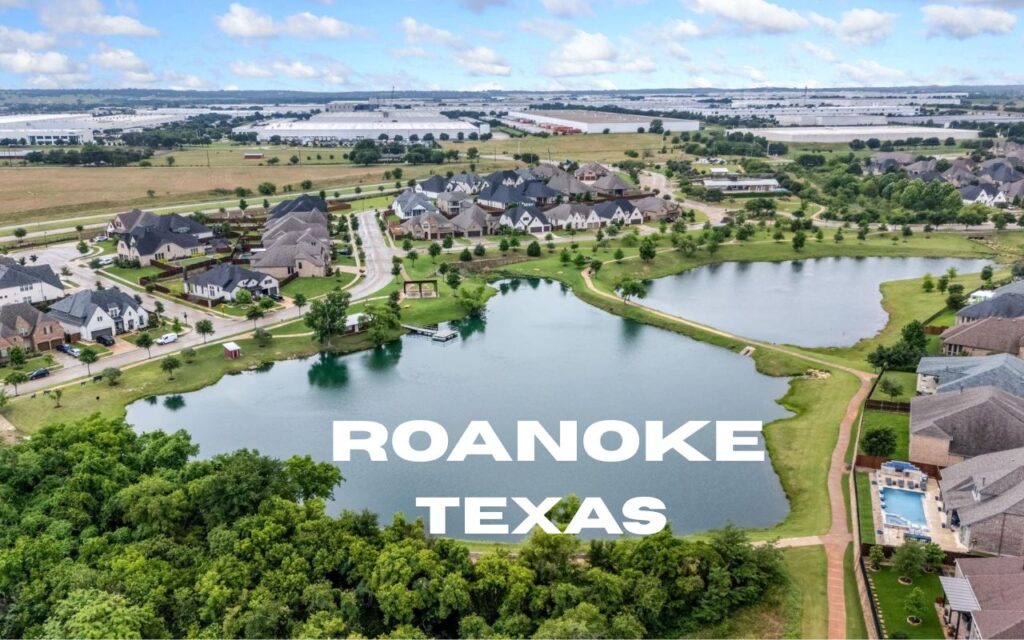 an aerial view of a lake with houses around it